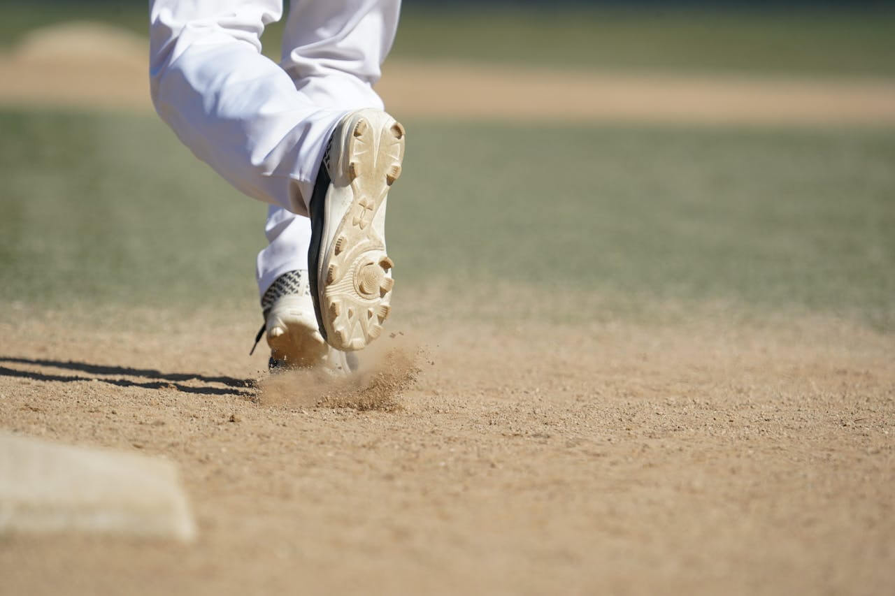 Comparison of youth baseball turf shoes with rubber nubs and molded cleats with plastic lugs.