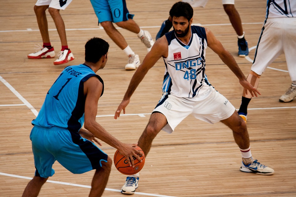 Basketball player intensely facing opponent during a competitive game, capturing focus and emotion on court