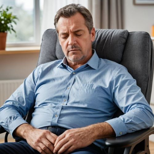 중년 남성이 만성피로증후군으로 의자에 앉아서 졸고 있다.