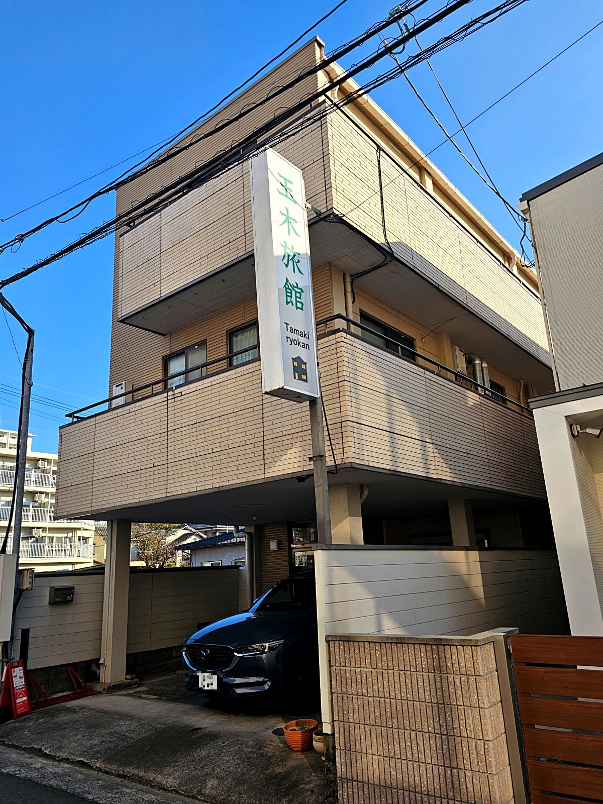 Tamaki Ryokan exterior during the day&amp;#44; traditional Japanese inn in Kumamoto