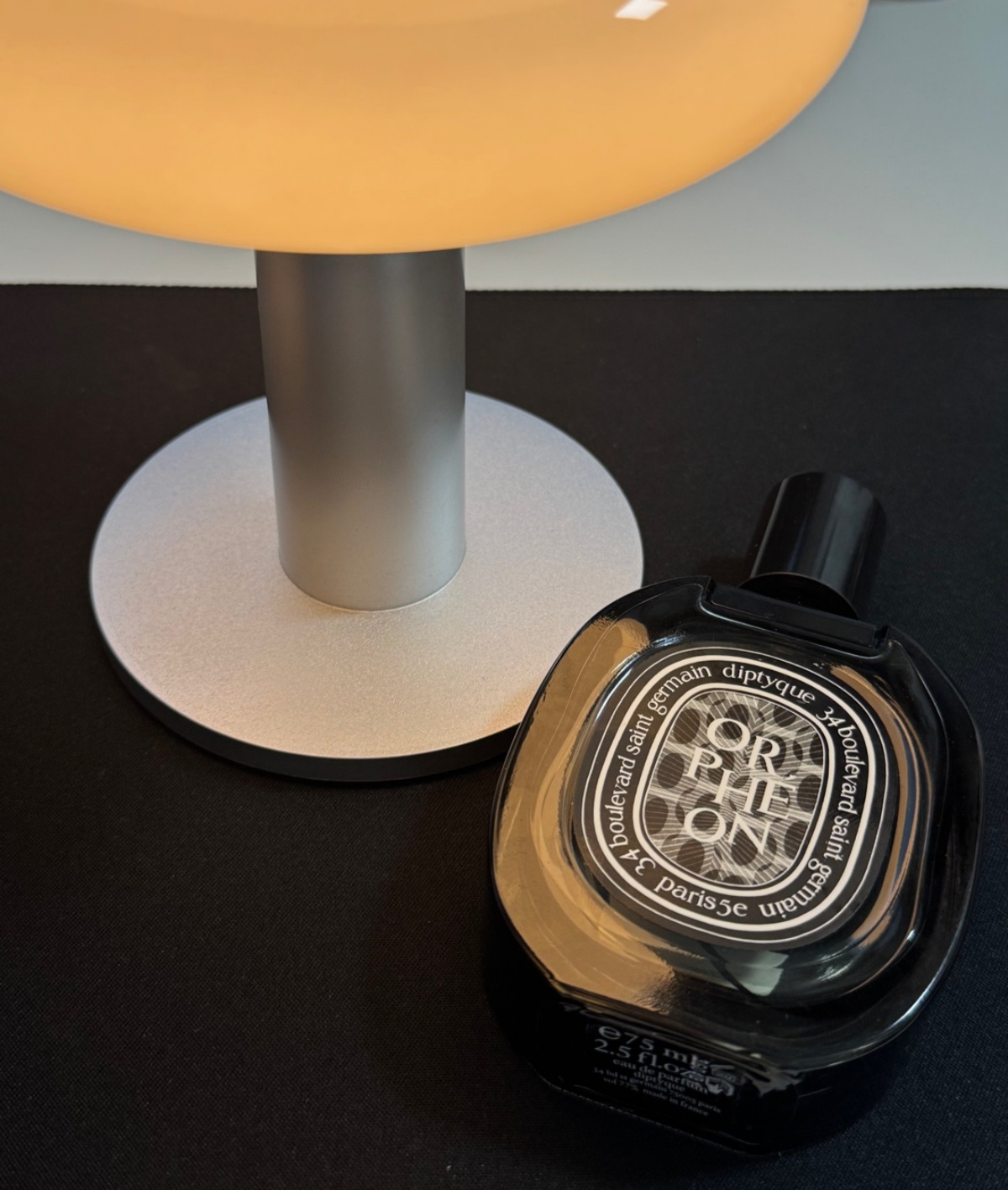 딥디크 오르페옹 향수병과 램프가 찍힌 감성적인 사진