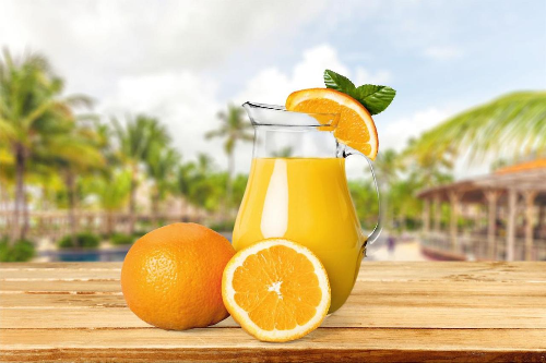 Fresh orange carrot juice served cold in a glass