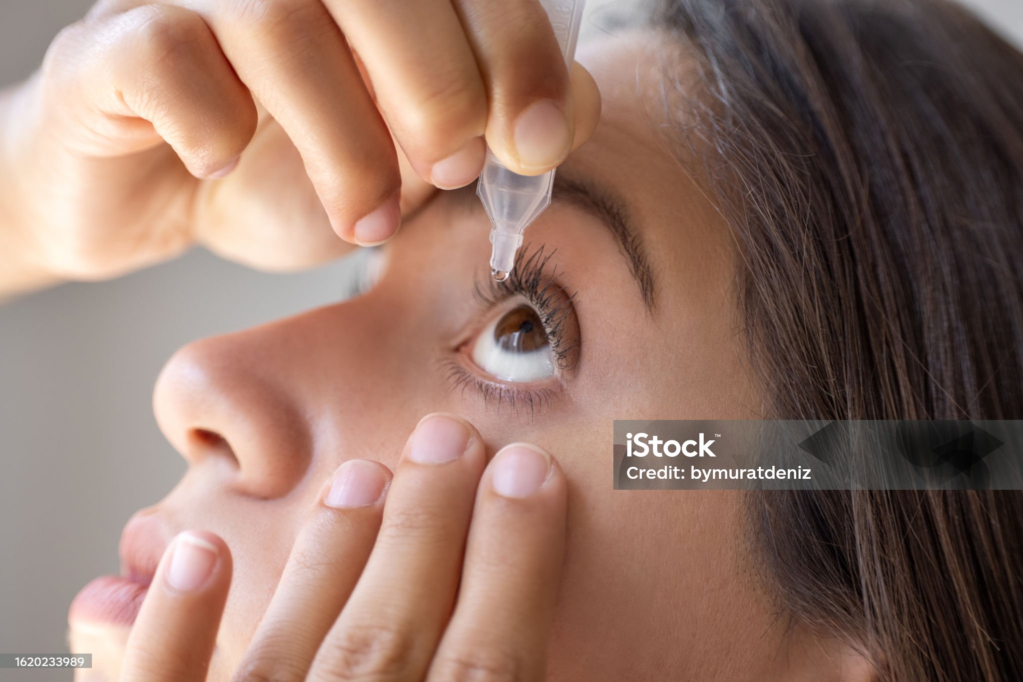 한 여자가 눈에 약을 주입한다.