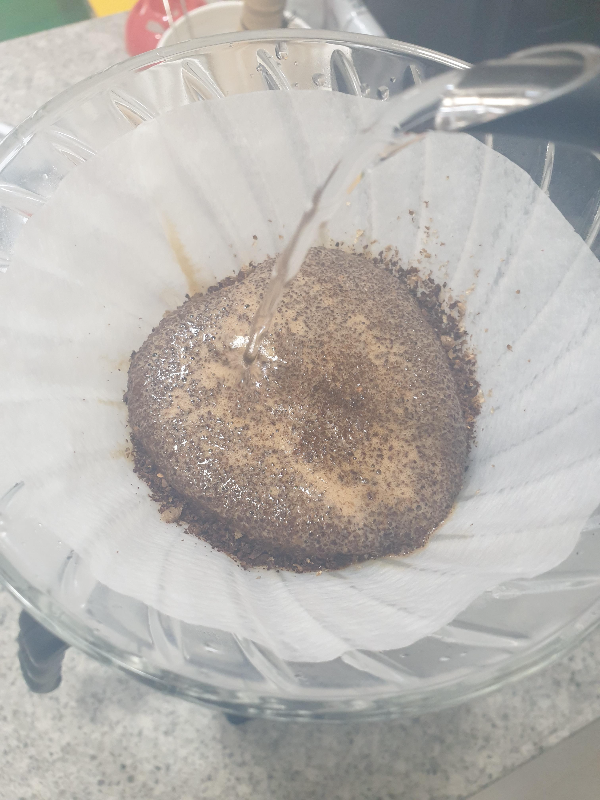 원두가 담긴 드리퍼에 뜸 들이기 진행 중. 커피가 빵빵하게 부풀어져 있다.