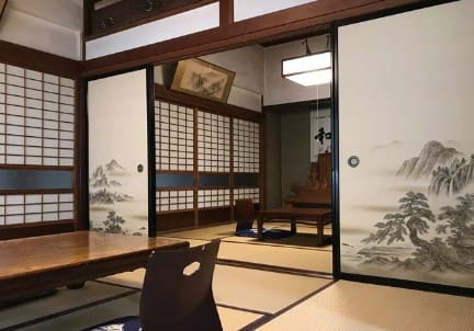 오래된 듯한 타다미와 좌식의자 좌식 테이블이 있는 실내