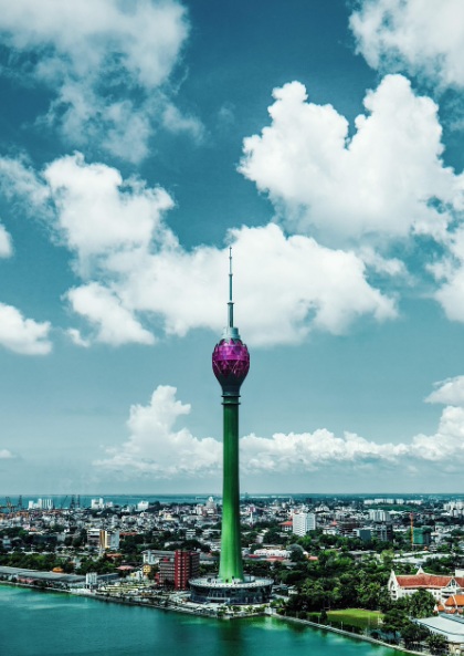 스리랑카 콜롬보의 랜드마크인 로터스 타워(Lotus Tower) 전경. 푸른 하늘과 흰 구름 아래 베이라 호수와 콜롬보 도심 마천루가 어우러진 풍경.