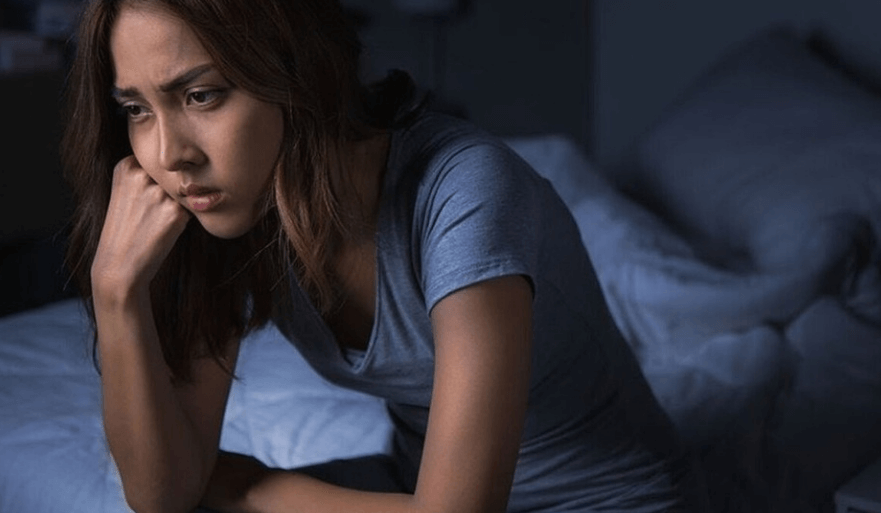 팽이버섯 효능은 피로 해소 도움이 된다. 침대에 앉아서 피곤해 하는 여성