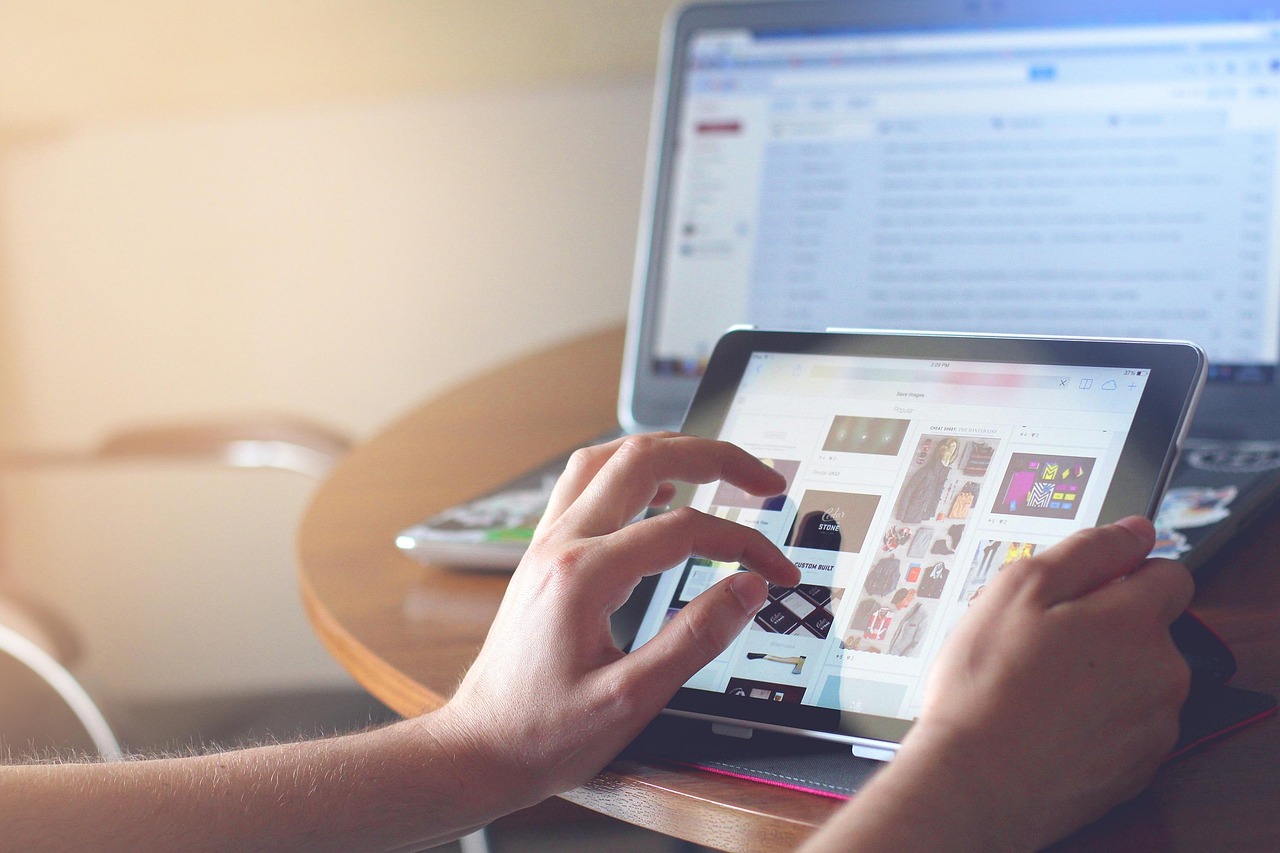 Hands making an online payment with a credit card and laptop