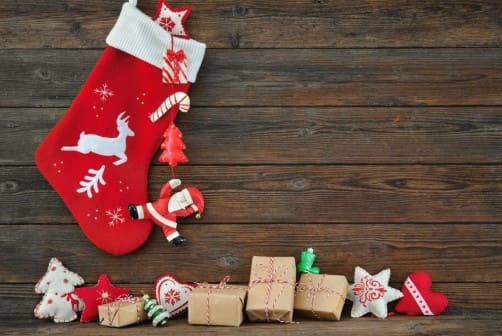 크리스마스 양말이 걸려 있고 밑으로 작은 선물꾸러기들이 놓여져 있다.
