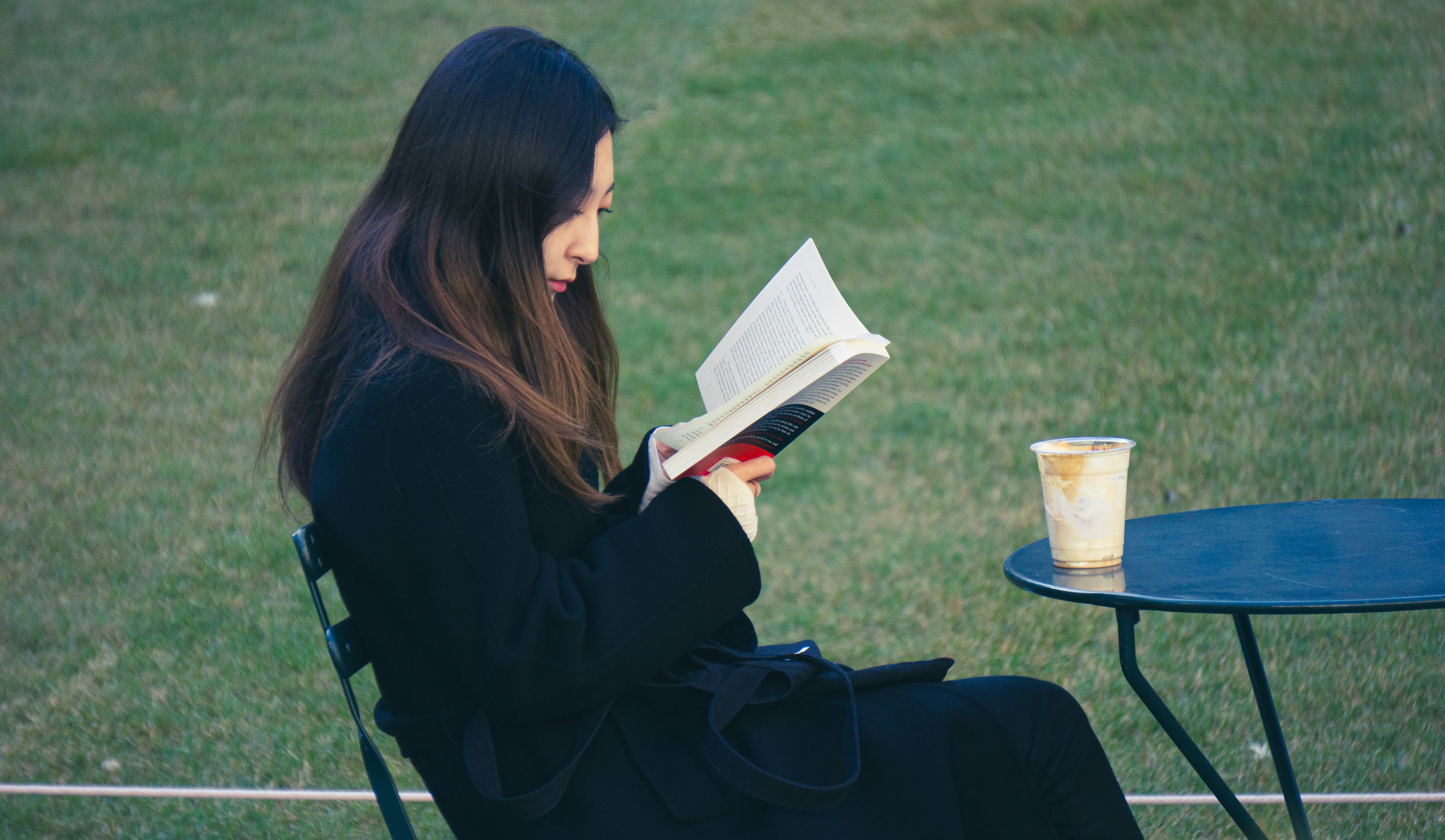 woman reading book comfortably