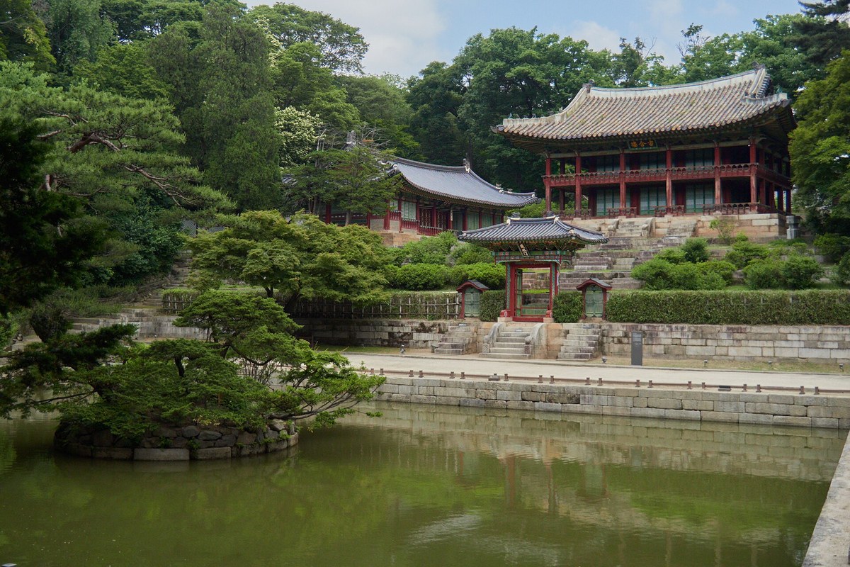 Juhamnu pavilion and garden buildings seen across the rectangular Buyongji Pond in the Changdeokgung Secret Garden