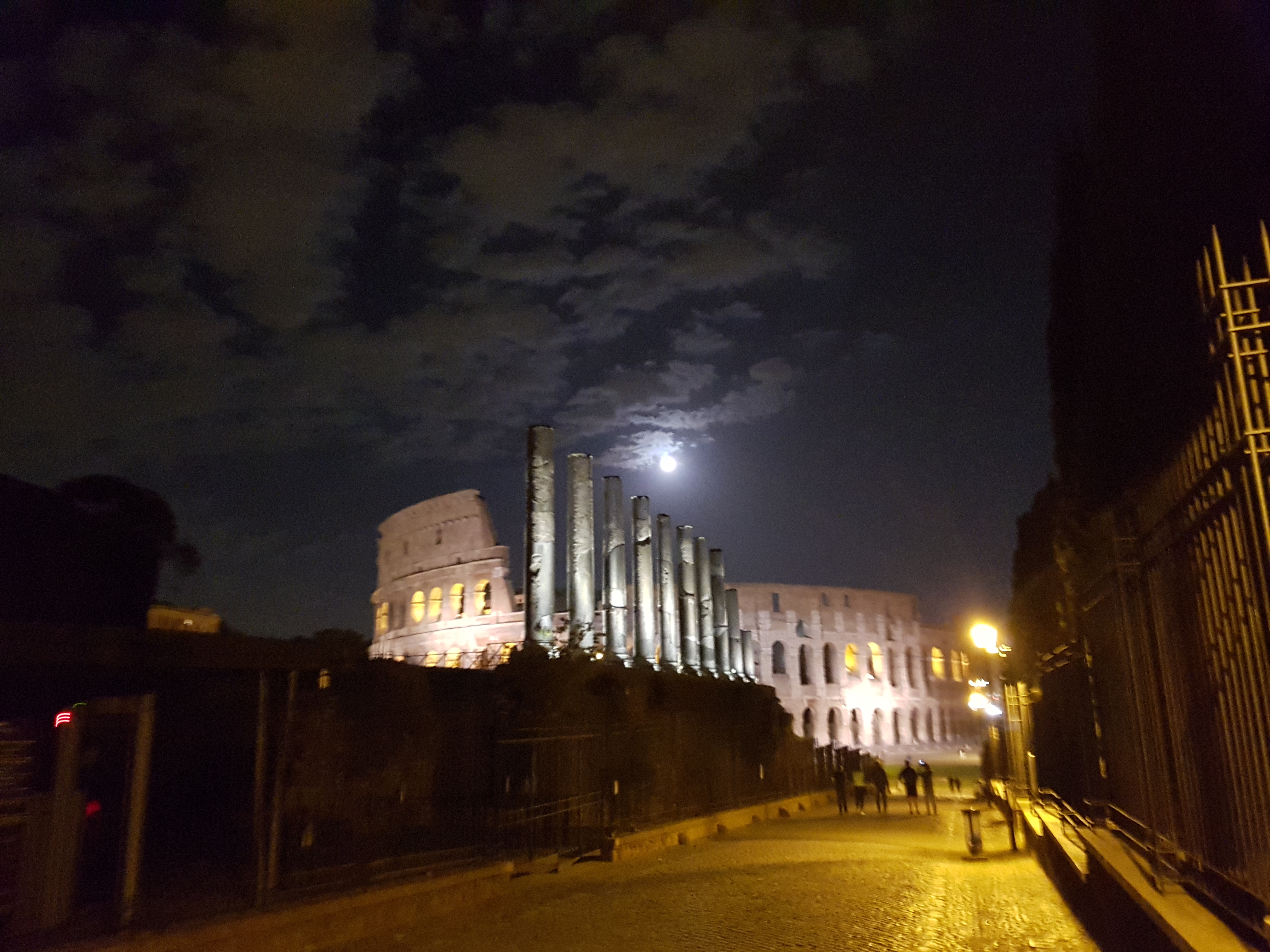 보름달이 뜬 밤, 조명을 받아 황금빛으로 빛나는 고대 로마 유적과 콜로세움의 야경