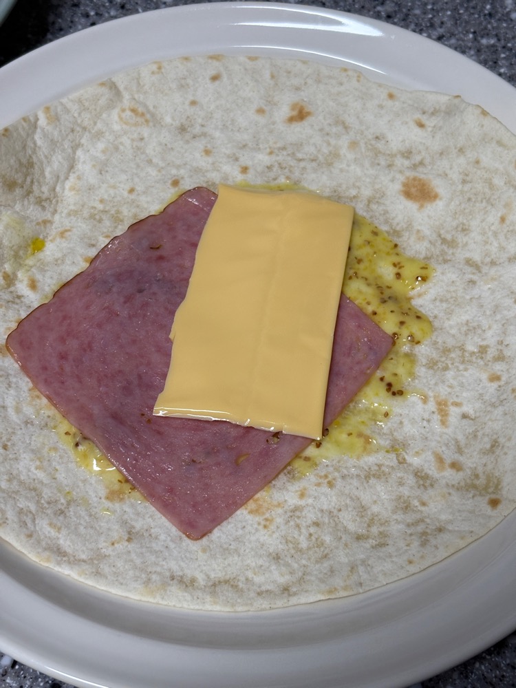 또띠아 위의 슬라이스 햄과 치즈