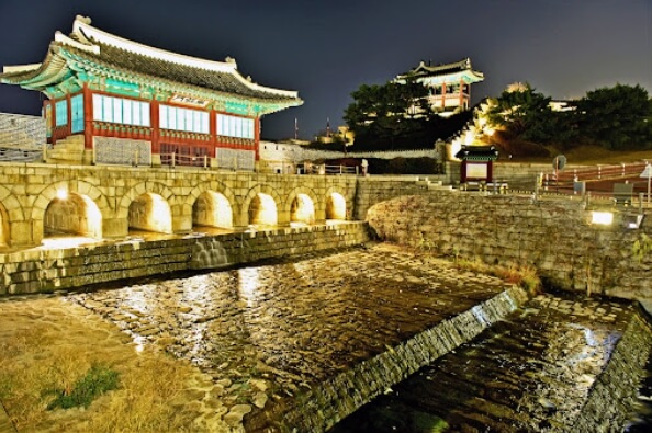 수원화성 화홍문 야경과 수원천의 물 흐름&amp;#44; 아치형 수문과 조명 반영이 어우러진 아름다운 풍경
