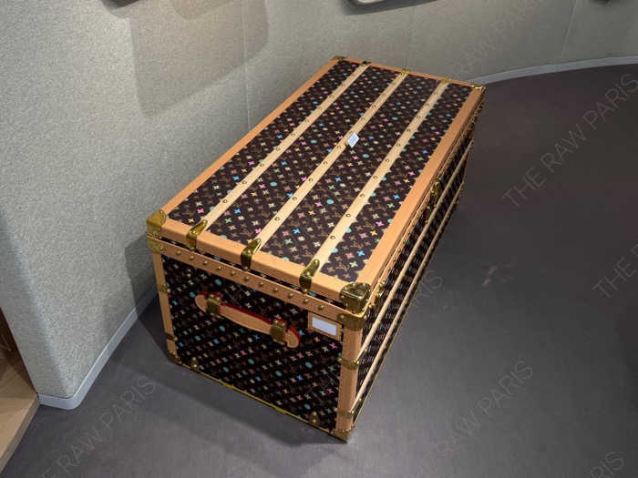 A luxury Louis Vuitton monogram travel trunk with colorful multi-color logo pattern displayed at LV DREAM Paris ❘ Une malle de voyage de luxe Louis Vuitton monogramme avec un motif de logo multicolore expos&eacute;e &agrave; LV DREAM Paris⁠