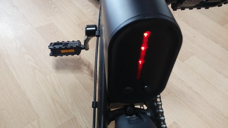 Battery unit of the Ideawalk electric bike showing LED lights turned on