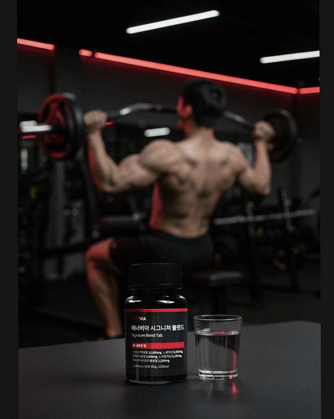Korean Asian man in his 40s taking supplements at dinner table
