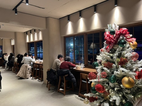 사람들로 북적이는 고낙온 매장 내부와 광안대교뷰를 감상할 수 있는 창가 다찌석 모습