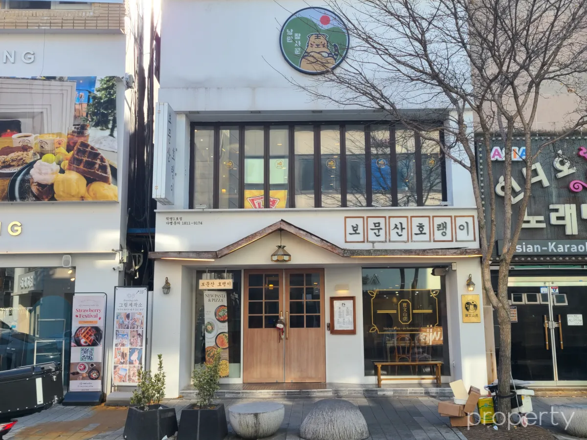 보문산호랭이건물-하얀색2층건물-우드톤으문과간판-따뜻한느낌이든다