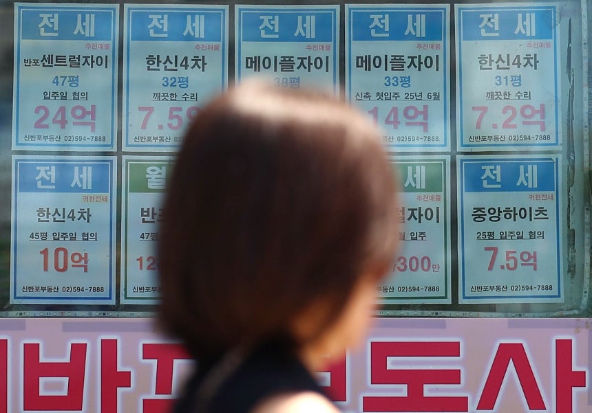 23일 서울 시내의 한 부동산에 붙은 전세 매물 안내문 앞으로 시민이 지나고 있다.