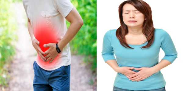 복통으로 괴로워 배를 부여잡고 있는 남과 여