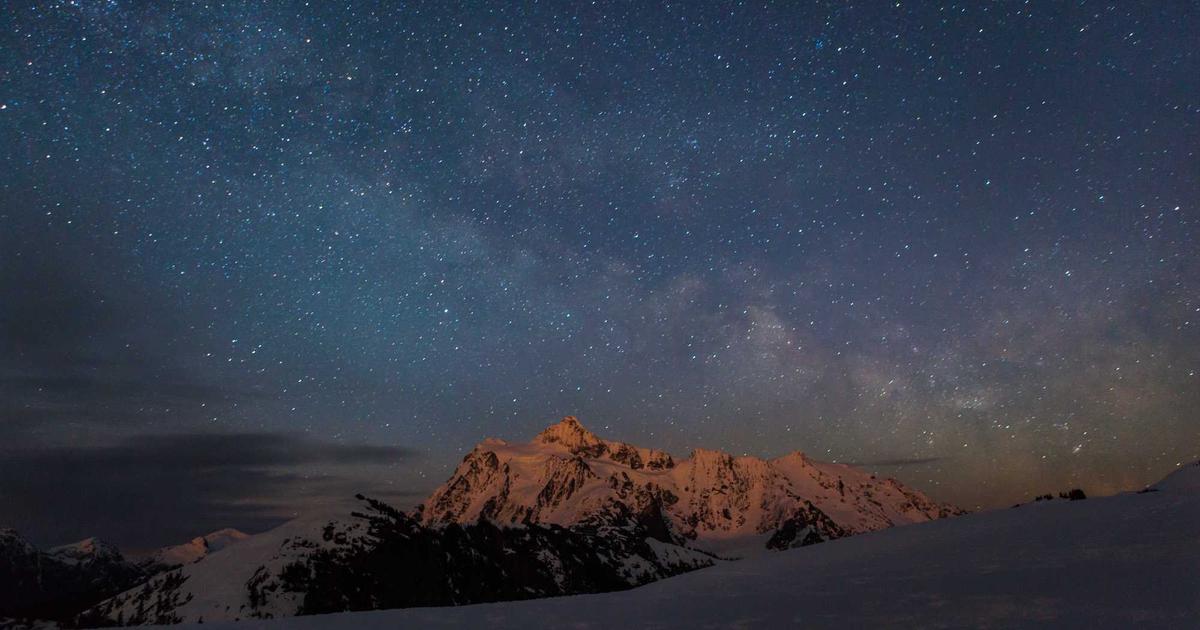 person cooking in a modern kitchen using a tablet with AI recipe app
