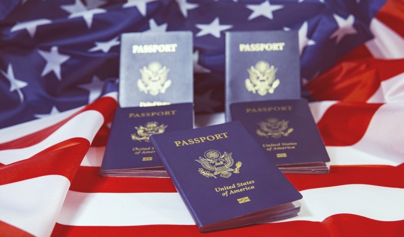U.S. Passports on American Flag – Representing Preparation for U.S. Religious Worker Visas and Immigration
