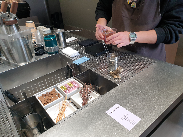 Good Enough 음료를 만들어 제공 중인 바리스타