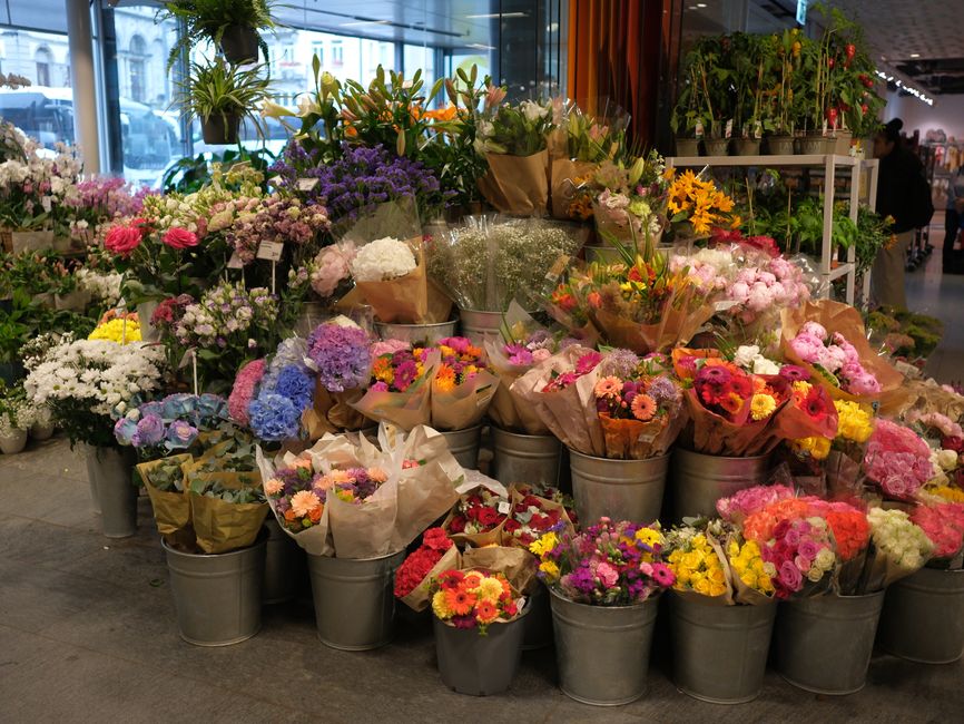 Colorful display of assorted flowers in a Zurich florist shop, showcasing diverse blooms and bouquets.