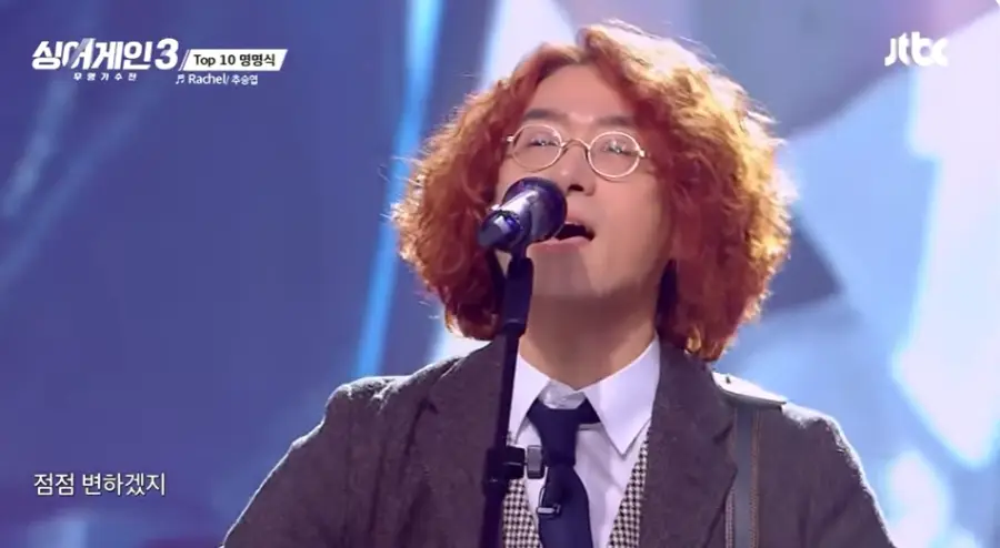 싱어게인3-
노란파마머리 금테안경 회색자켓 흰셔츠 남색 넥타이 체크무늬 조끼 스탠딩마이크에 노래한 59호