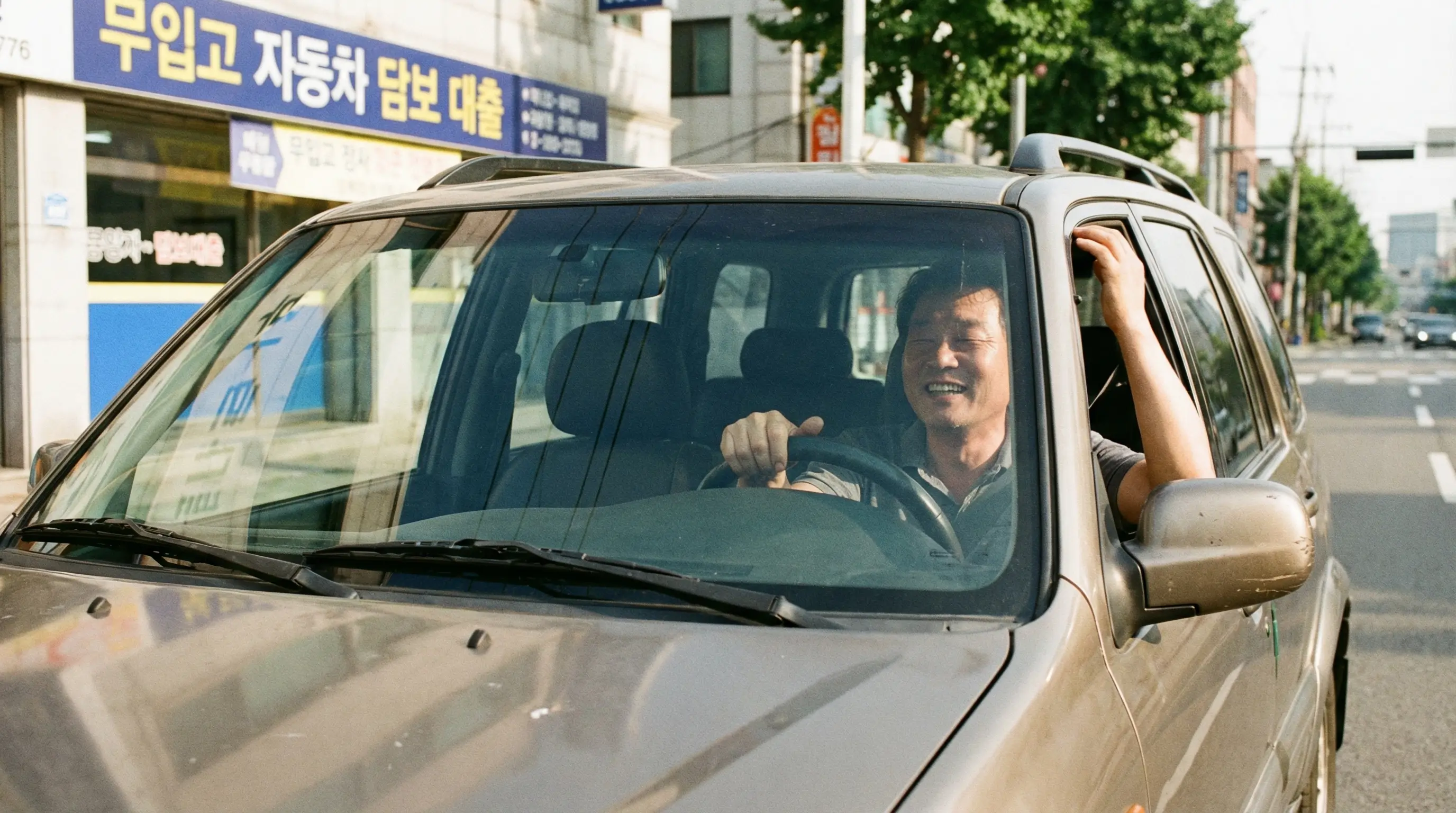 자동차를 담보로 대출을 받으면서도 차를 입고하지 않고 계속 운행하는 운전자의 안도하는 모습