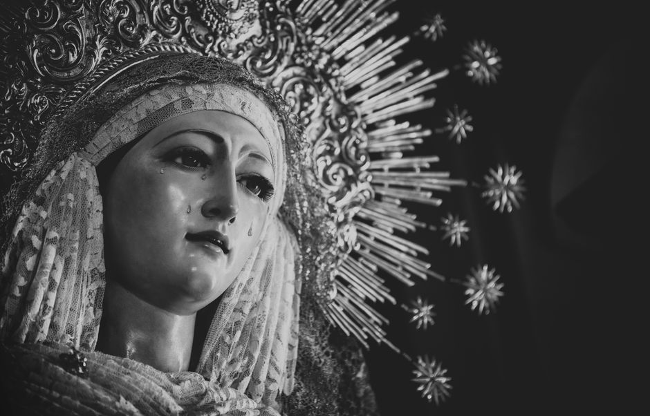 Black and white close-up of the Virgin Mary statue, emphasizing religious imagery and emotion.