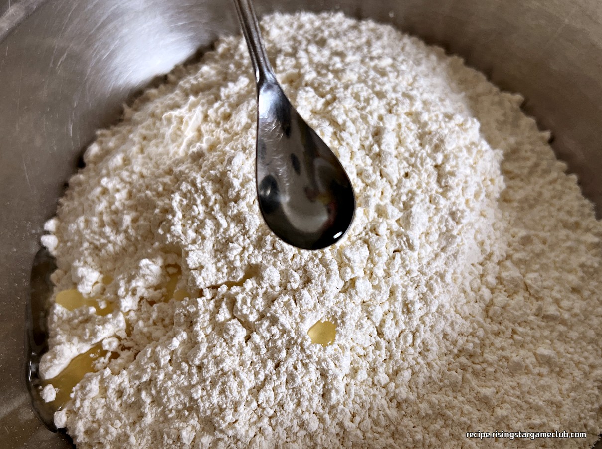 바지락 칼국수의 반죽을 할 밀가루에 식용유를 넣는 사진