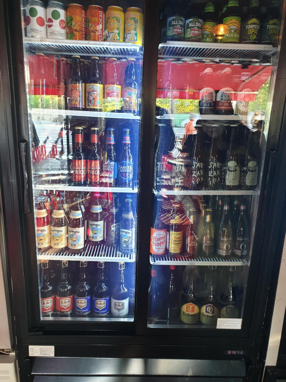 맥주 냉장고 하나. 맥주가 가득 채워져 있다.