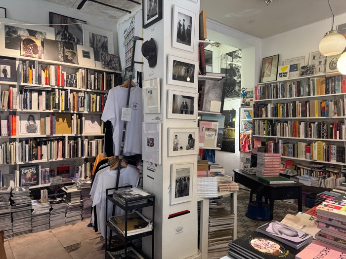 A wide view of the interior layout at Ofr Paris bookshop featuring high shelves filled with independent art books ❘ Inside Ofr Paris⁠