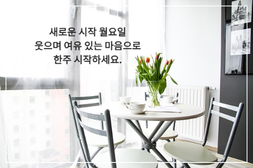 창가 앞 테이블 위 튤립 꽃 화병과 커피잔