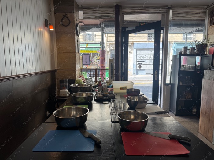 e cozy interior of Midam restaurant in Paris set up with long tables for the culinary workshop ❘ L'intérieur chaleureux du restaurant Midam à Paris aménagé avec de longues tables pour l'atelier culinaire