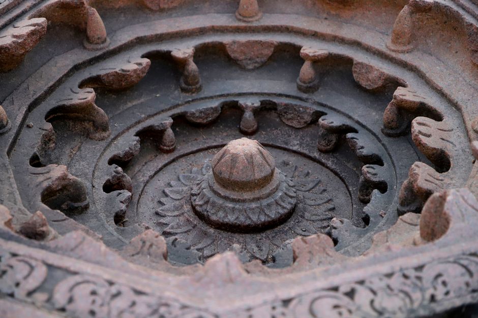 Close-up of a detailed stone mandala with intricate carvings, showcasing artistic craftsmanship.