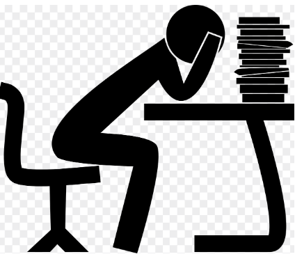 수험 도서를 쌓아 놓고 머리를 잡고 있는 이미지