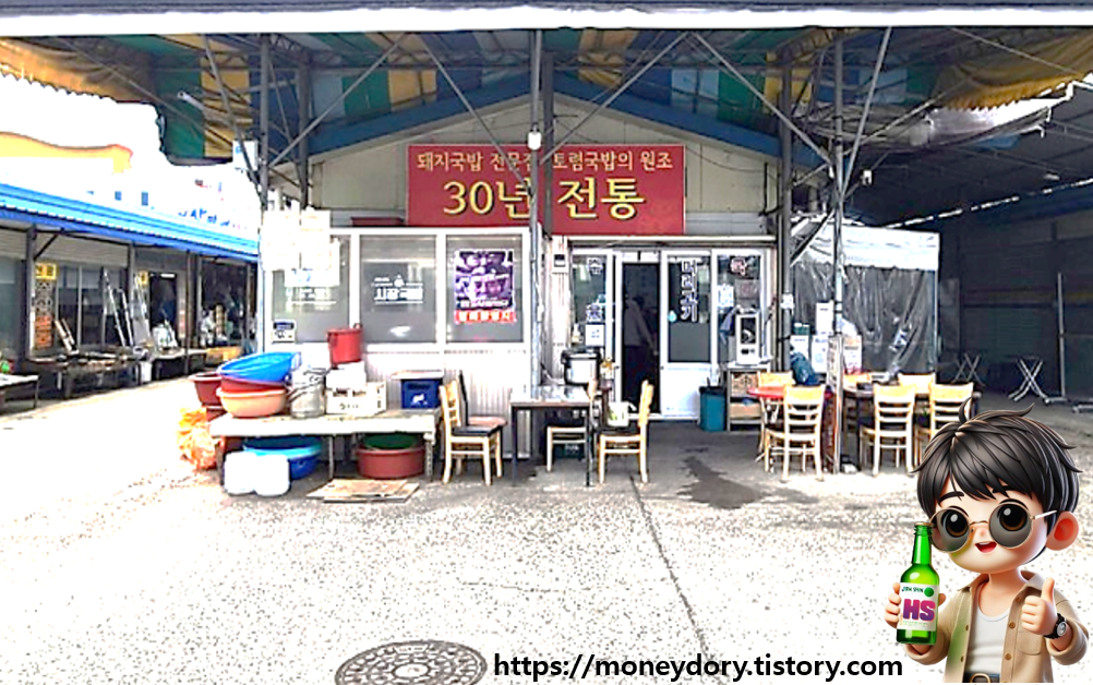 지붕 위에 천막이 설치되어 있고, 야외 테이블이 놓여 있는 광주 돼지국밥 맛집 가게 전경