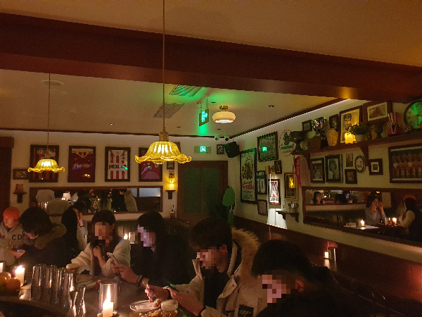 바안 사람들로 가득차있다. 벽면에는 액자들이 가득하다.