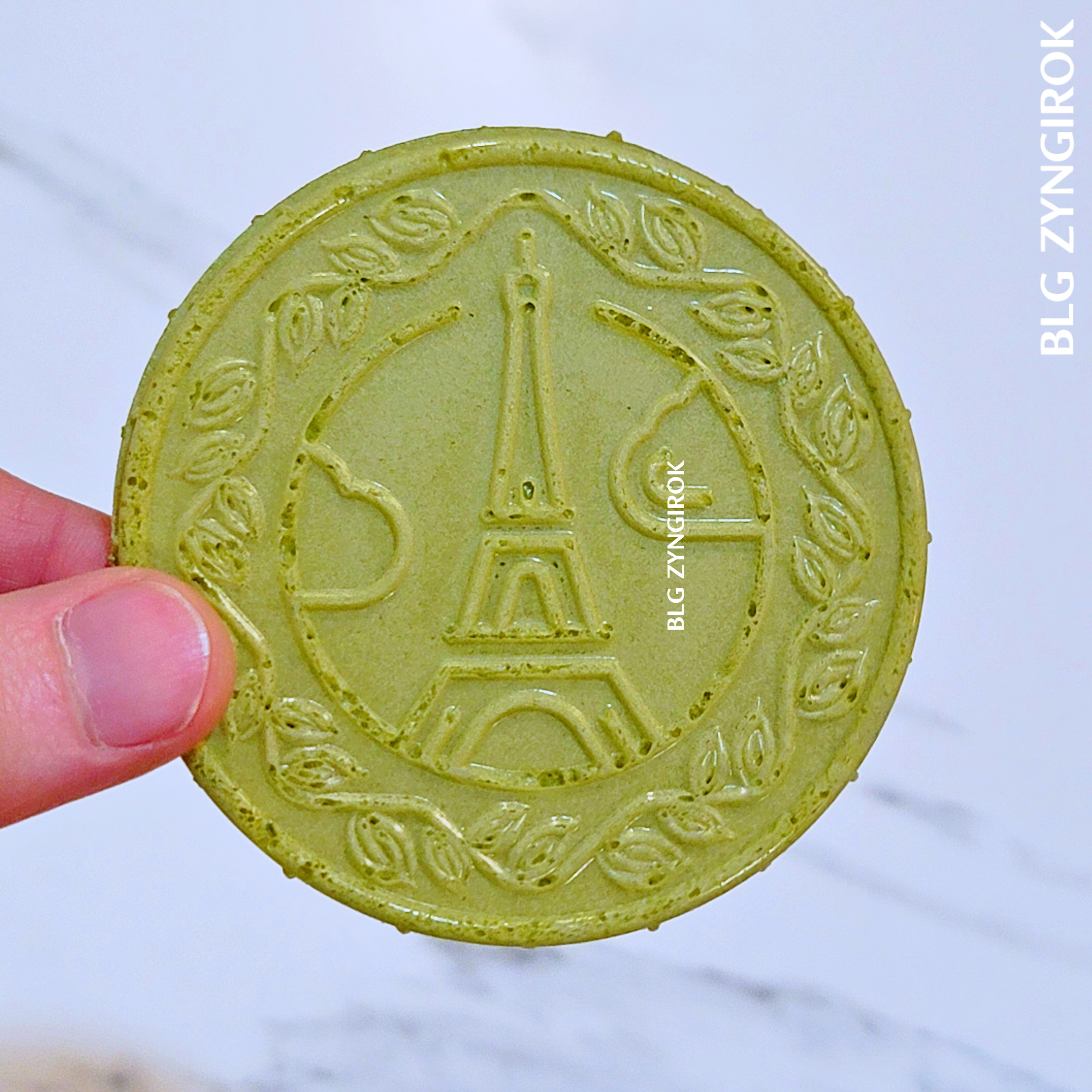 노브랜드 말차 샌드 웨이퍼를 들고 있다. 웨이퍼에 에펠탑이 그려져있다.