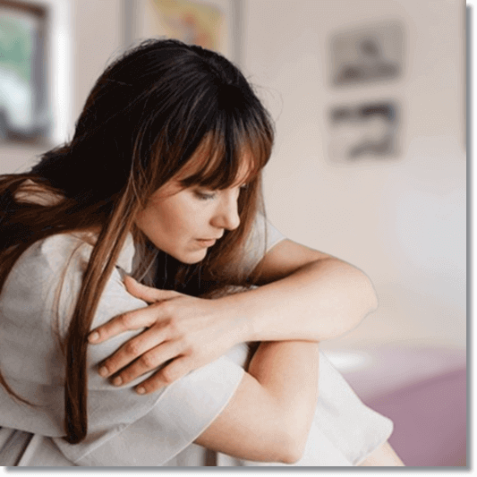 웅크리고 있는 심장판막증 여성