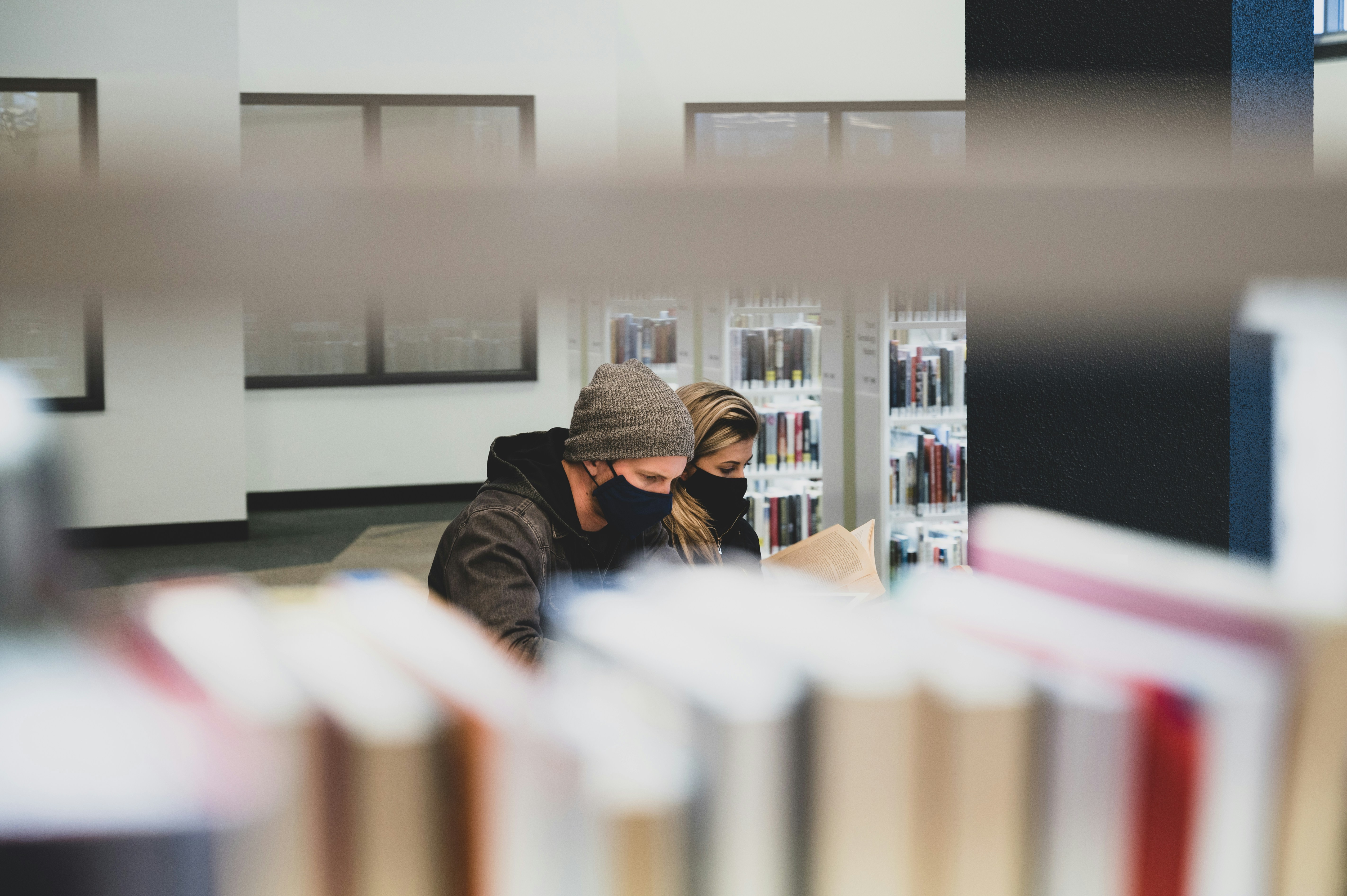 a person reading a book in a quiet library