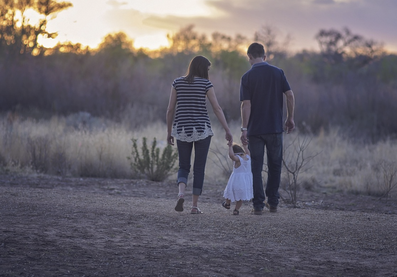 parents guiding a daughter to walk safely