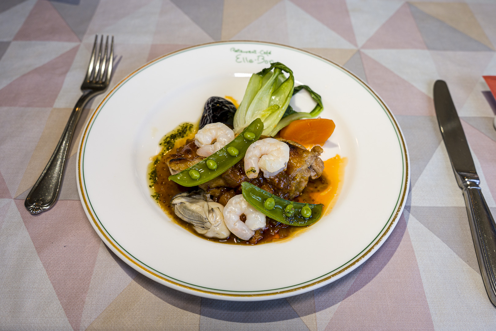 A plated dish with vegetables and sauce at Elle Bon