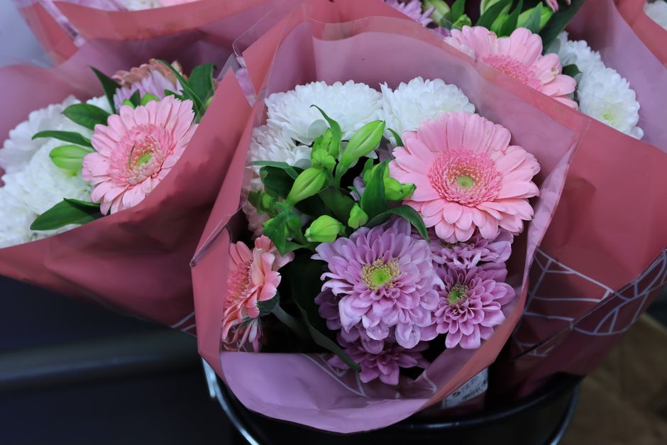 Stunning floral bouquets wrapped in pink paper, perfect for weddings or romantic occasions.