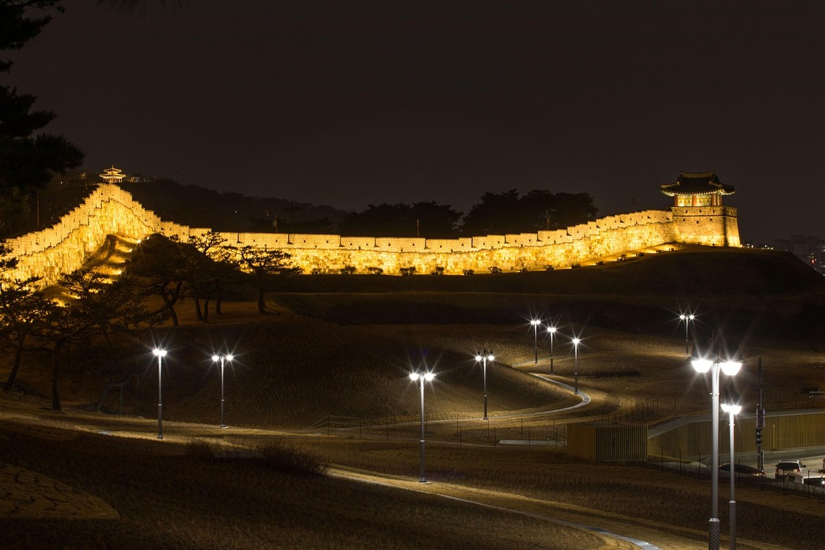 Illuminated stretch of Suwon Hwaseong Fortress wall and watchtower at night