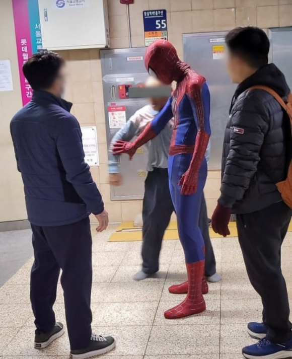 11일 서울 지하철 2호선 잠실역에서 역무원들을 위협하는 노숙인을 스파이더맨 복장을 한 시민이 제지하고 있다. [사진=인스타그램 캡처본]