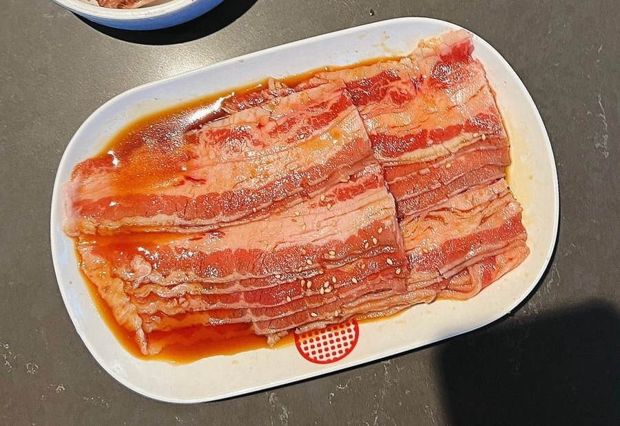 Thinly sliced sweet soy beef brisket ready to grill